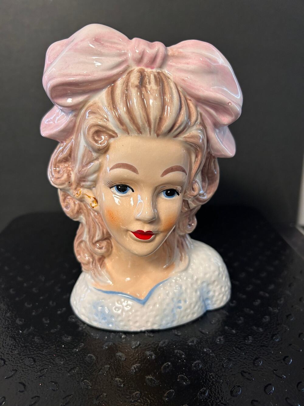 ceramic head vase features a detailed young lady with brown curls